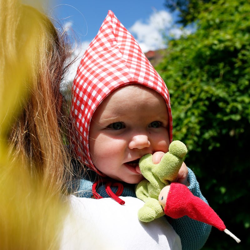 Nanchen Wichtel doll being held by baby