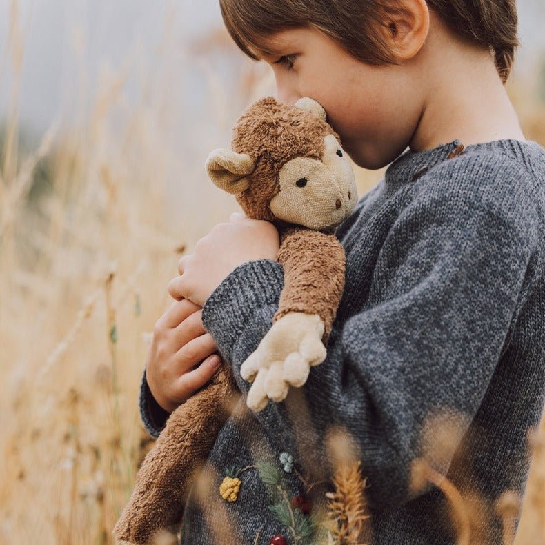 child with organic cotton senger monkey